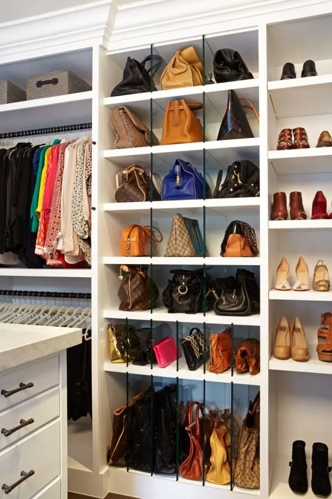 White closet shelves with clear acrylic dividers keeping colorful handbags upright and separated.