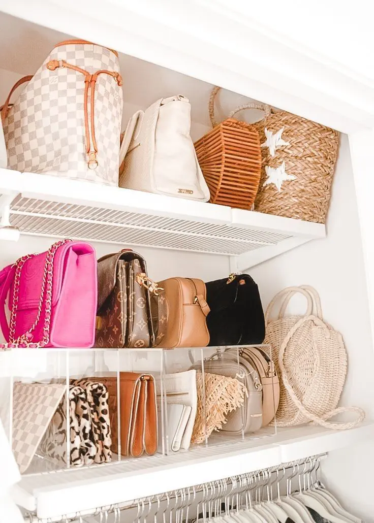 Open closet with white wire shelving and clear acrylic dividers organizing handbags and accessories.