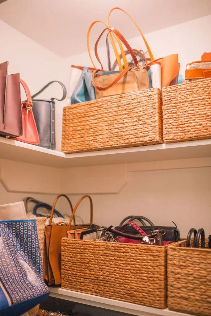 Woven baskets on shelves storing soft handbags and totes in a cozy, decorative way.