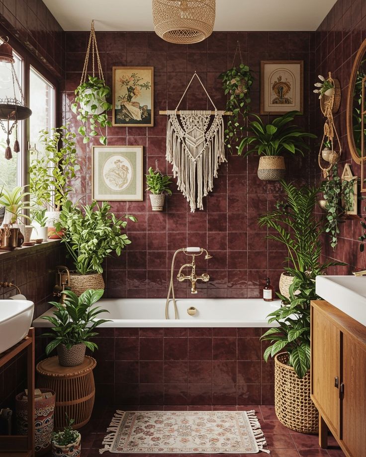 Mauve bathroom with large leafy plants and a small terracotta pot adding greenery against deep mauve walls.