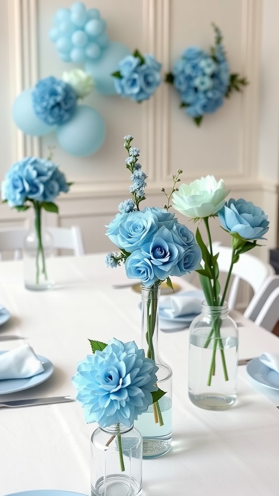 A table setting for a baby boy shower featuring blue flowers in glass vases, with balloons and floral decorations in the background.