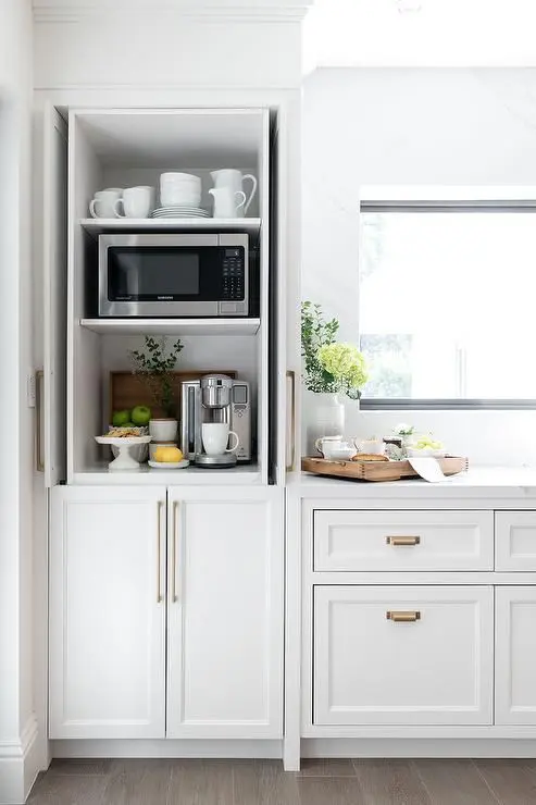 21 Luxury Kitchen Design Ideas for Your Dream Home 11 a small and narrow cabinet turned into a hidden tea or coffee bar with appliances mugs and a microwave too