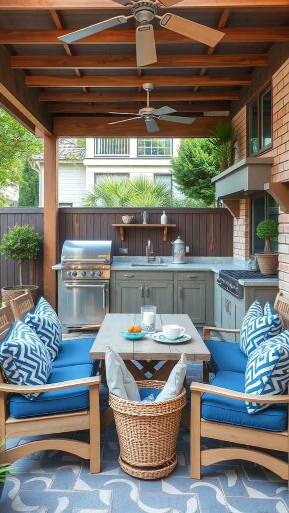 An outdoor kitchen patio featuring a grill, comfortable seating with blue cushions, a small table with drinks, and a ceiling fan.