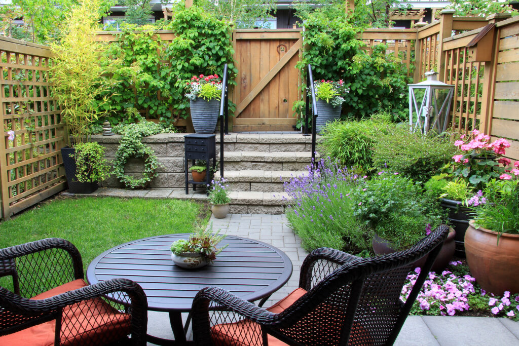 15 Small Back Garden Ideas to Transform Your Outdoor Space small,townhouse,garden,with,patio,furniture,amidst,blooming,lavender.