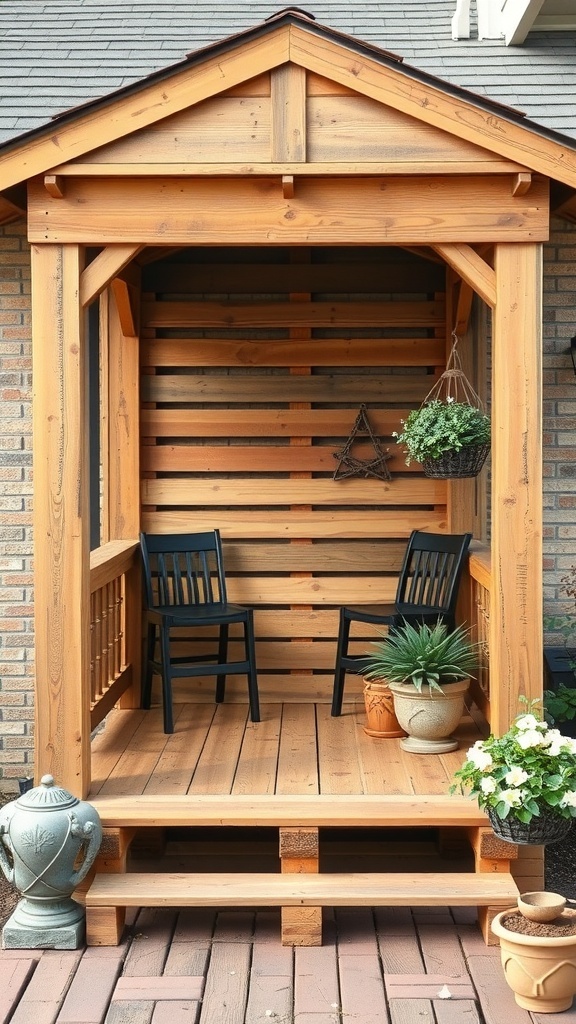 A cozy DIY pallet wall enclosure on a porch with two black chairs and potted plants.