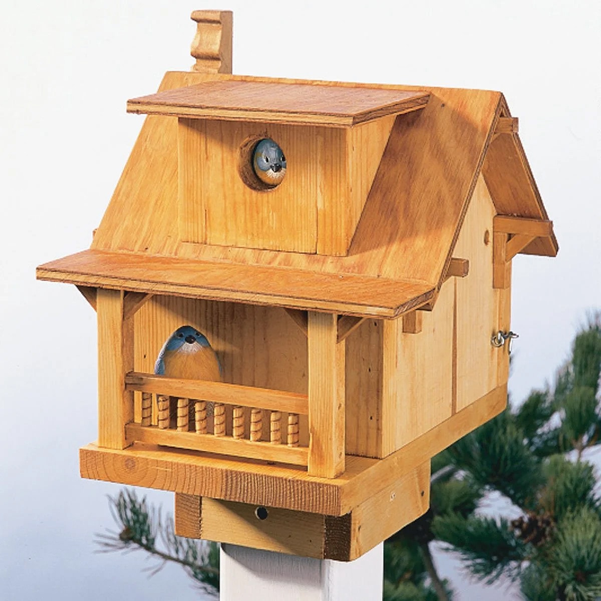The Miniature Mansion Estate two story birdhouse with wrap around porch and chimney.