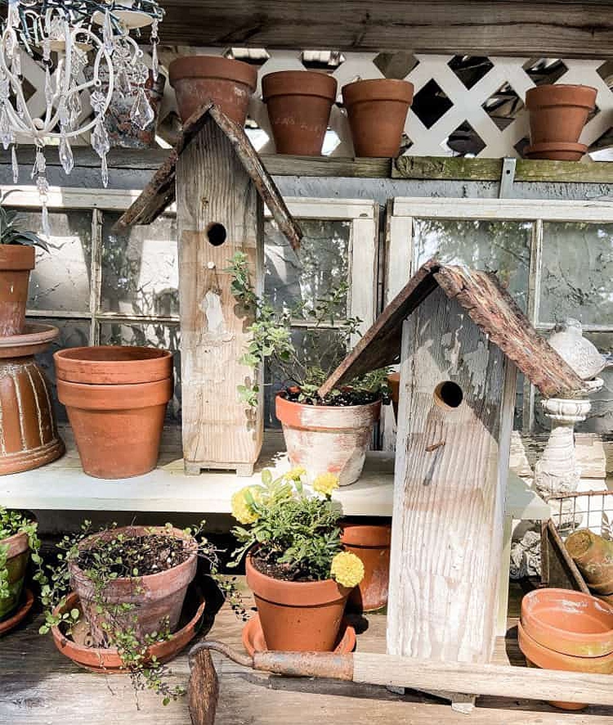 Salvaged Chic Skyscrapers tall skinny birdhouses made from weathered wood and corrugated metal roofs.