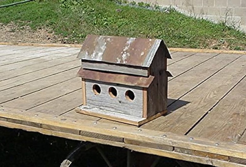 Reclaimed pallet wood A frame birdhouse with mismatched wood tones.
