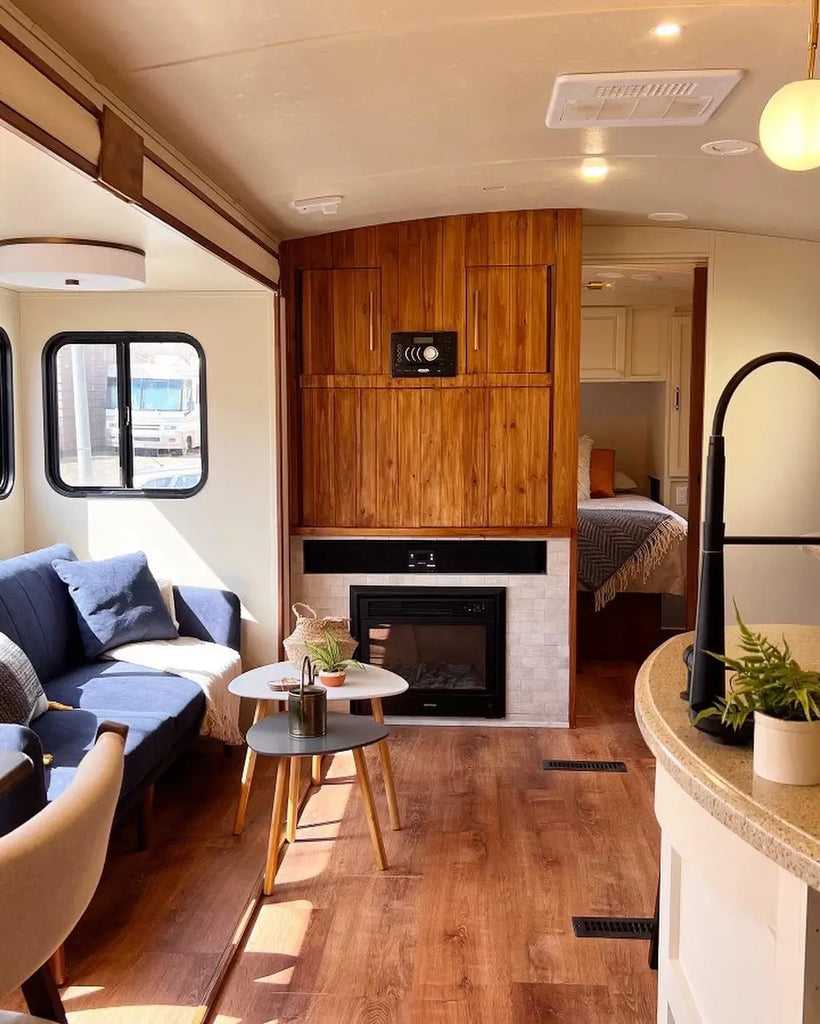RV living area with warm wood accents and fireplace