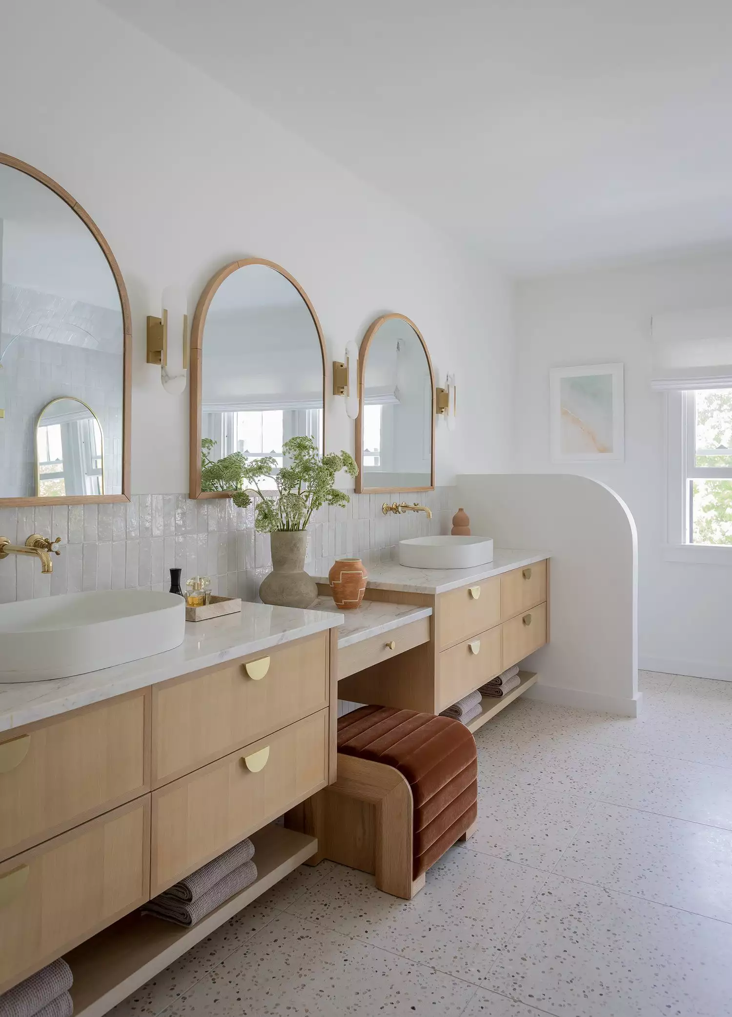 Playful bathroom with a terrazzo vanity top, mint green vessel sink, white tile walls, and a peach-toned upper wall.