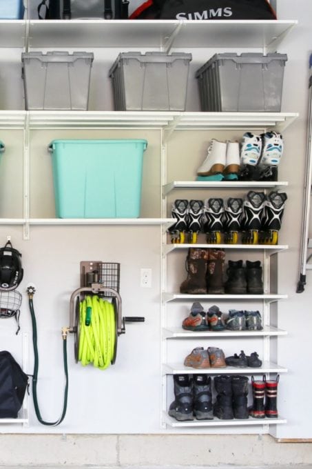 Slim vertical shoe rack mounted beside garage door