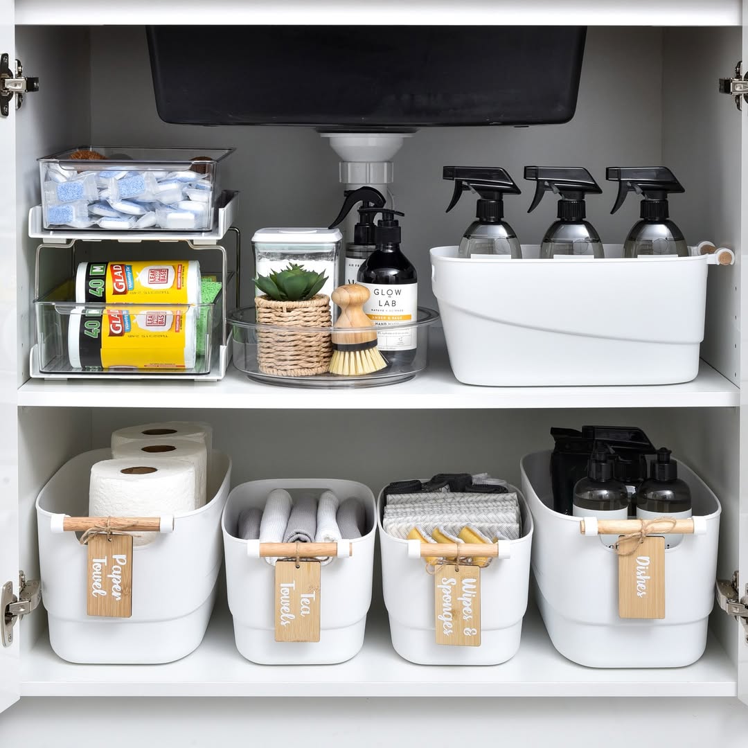Clear stackable acrylic drawers organizing hair and skincare products under bathroom sink