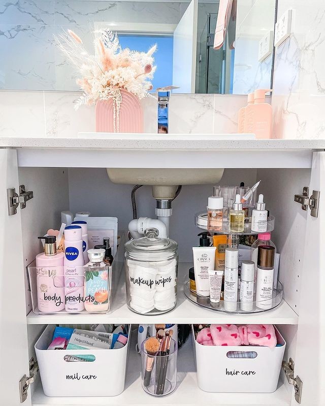 Rotating tray with skincare products under bathroom sink