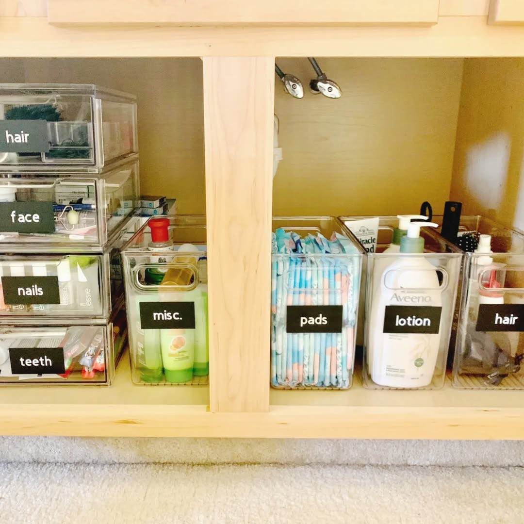 Clear labeled drawers organizing medicine and dental supplies under sink