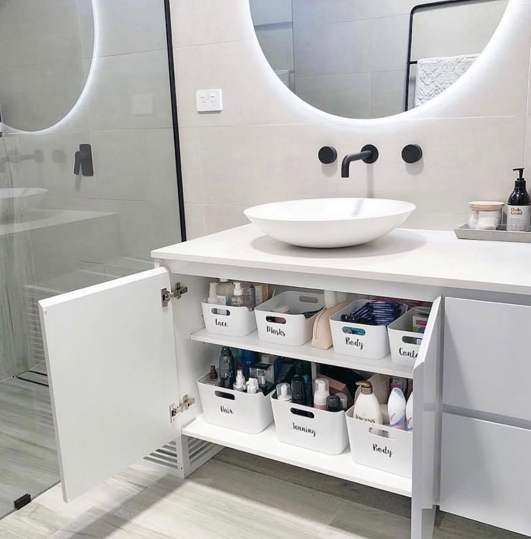Minimalist cleaning supplies neatly organized under bathroom sink